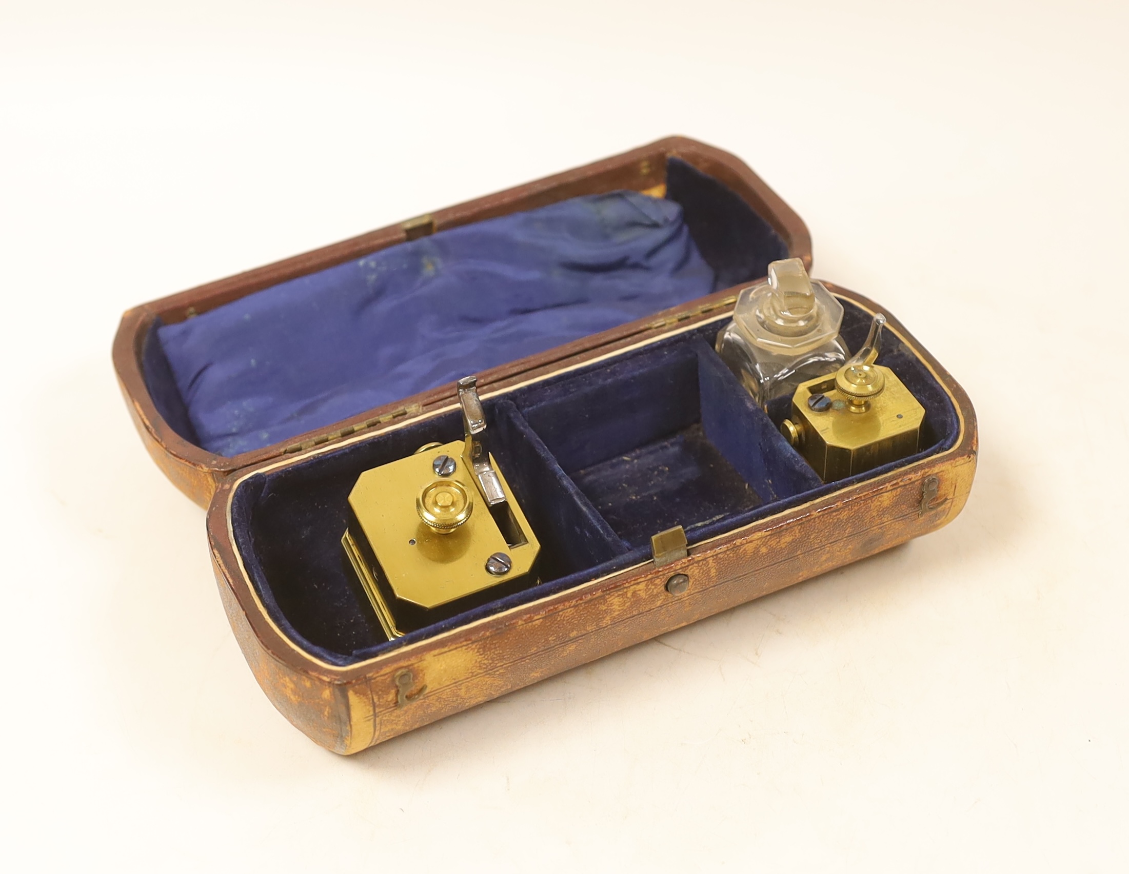 Two 19th century brass blood letting scarificators, cased, case 21cm wide